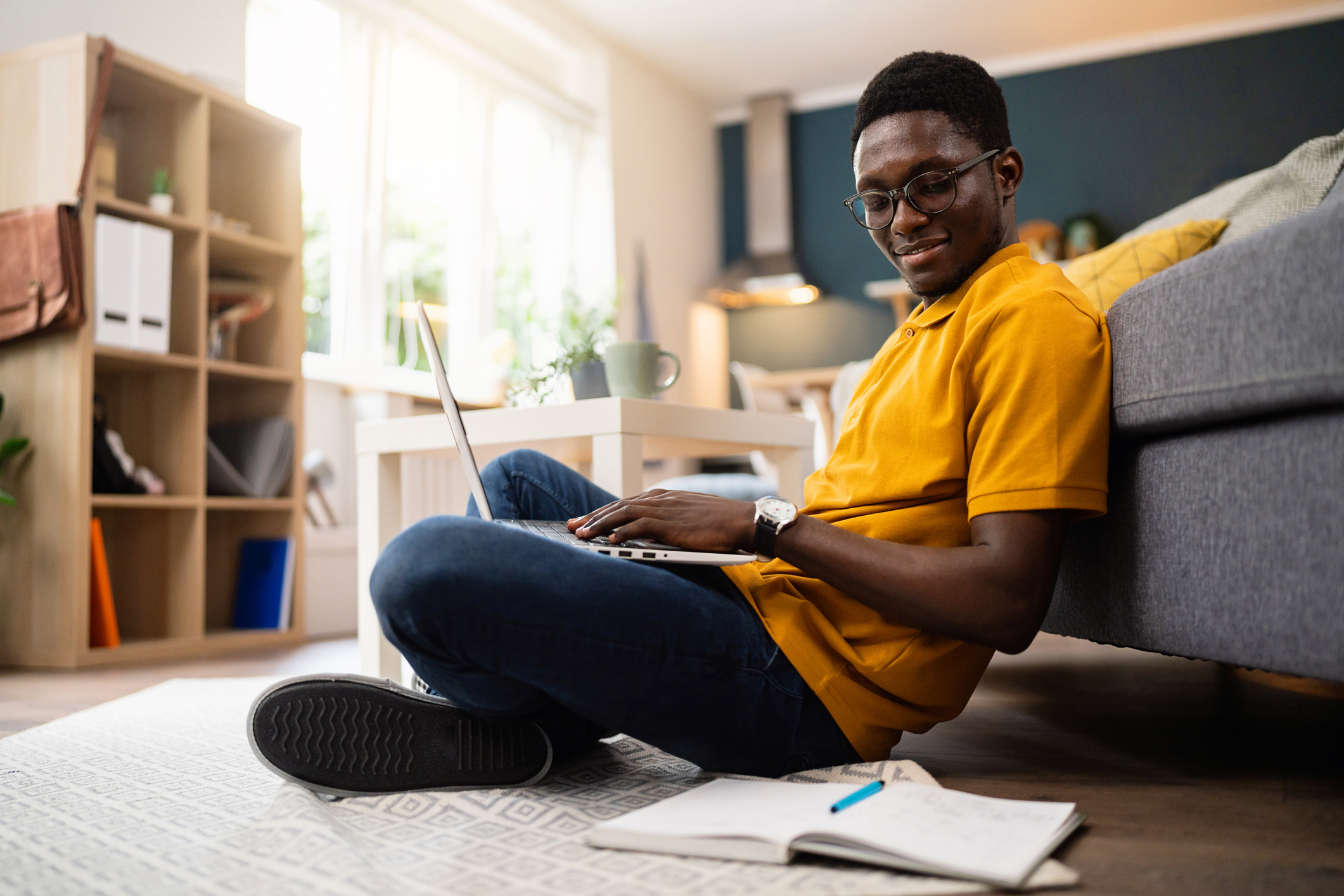 Man African-American ethnicity working on laptop from home